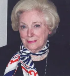 Portrait of Beryle Bell, smiling, wearing a patterned scarf