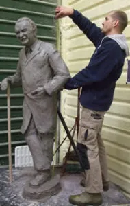 Sculptor Jacko working on the clay figure of Guttmann